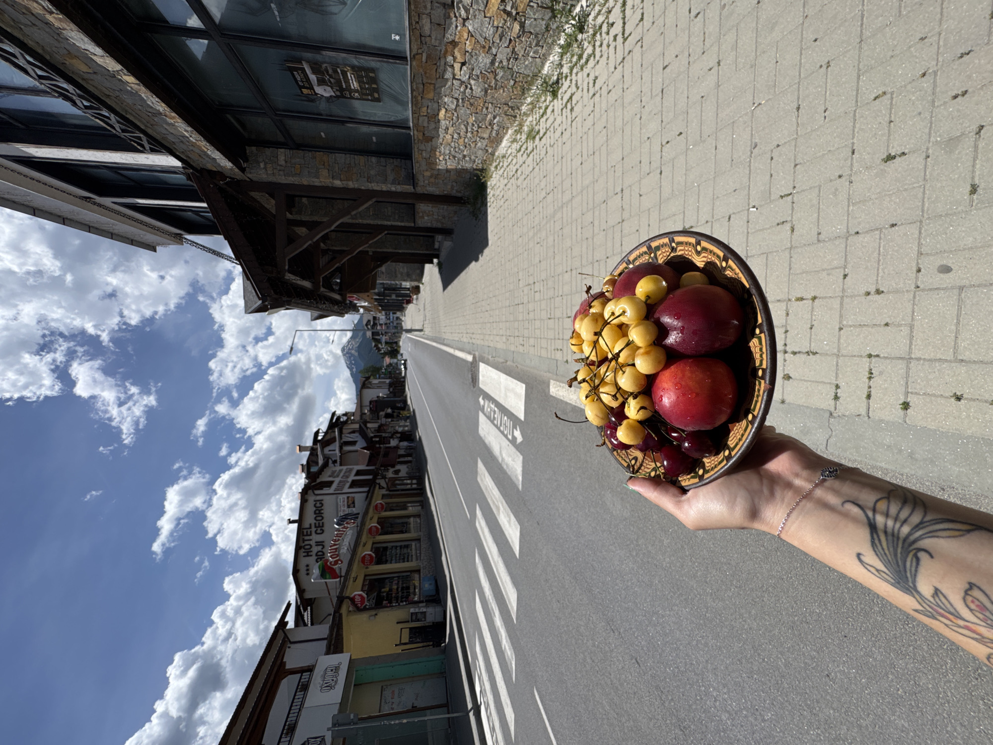 Fresh cherries and peaches on a decorative plate in Bansko