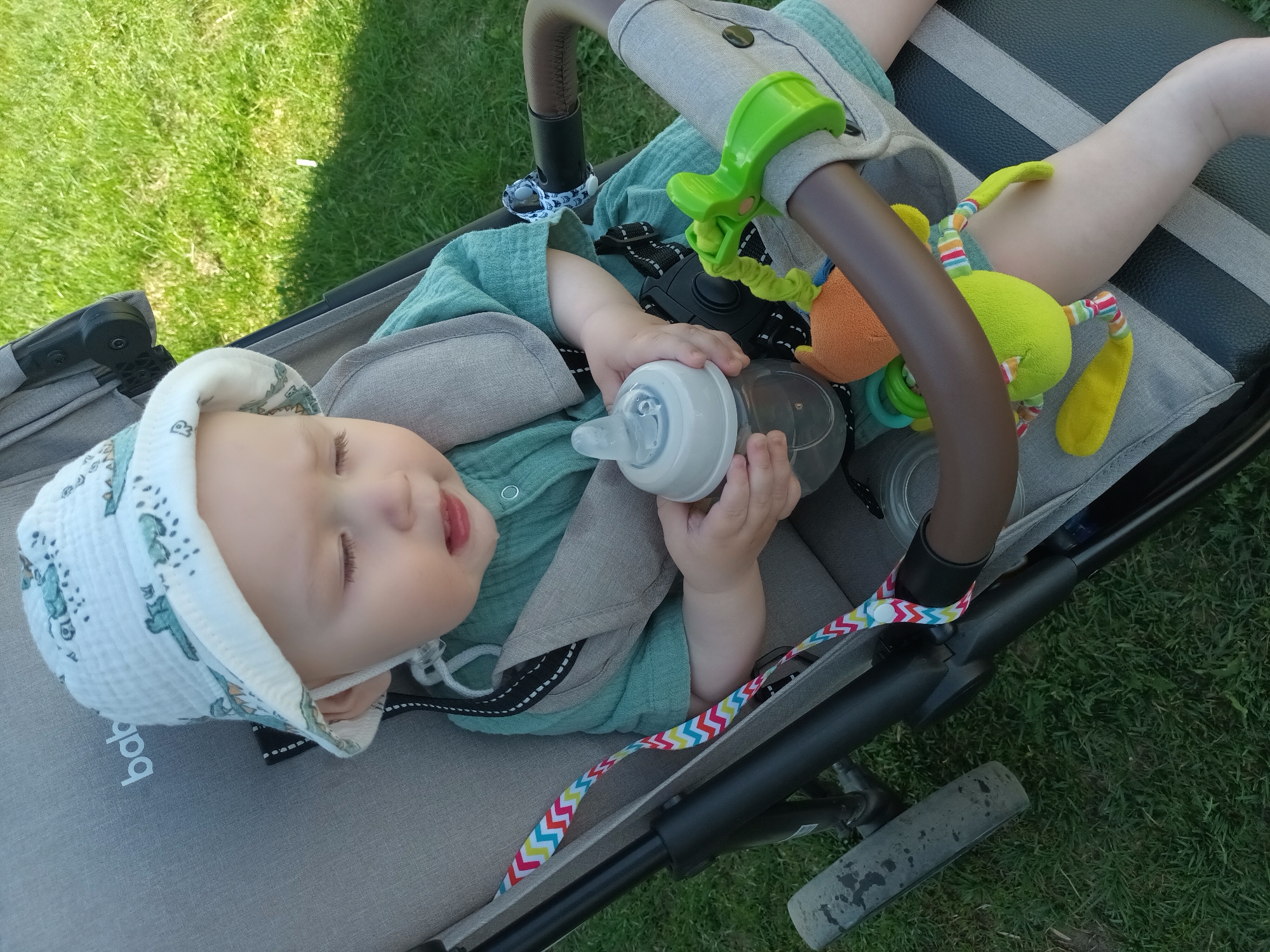 Baby observed in stroller on lawn in Ольховка, Russia