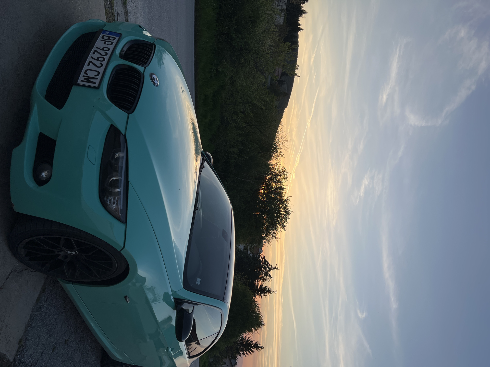 Turquoise BMW spotted during sunset in rural Bulgaria