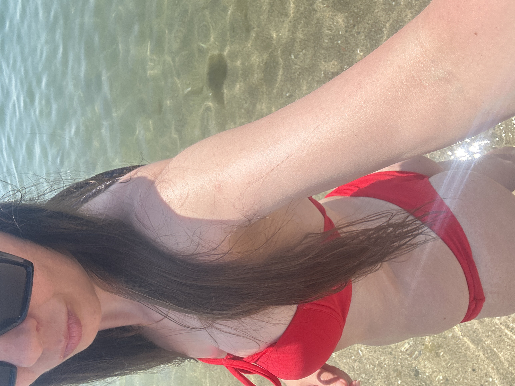 Sunny morning at Barceloneta beach, red bikini, clear water