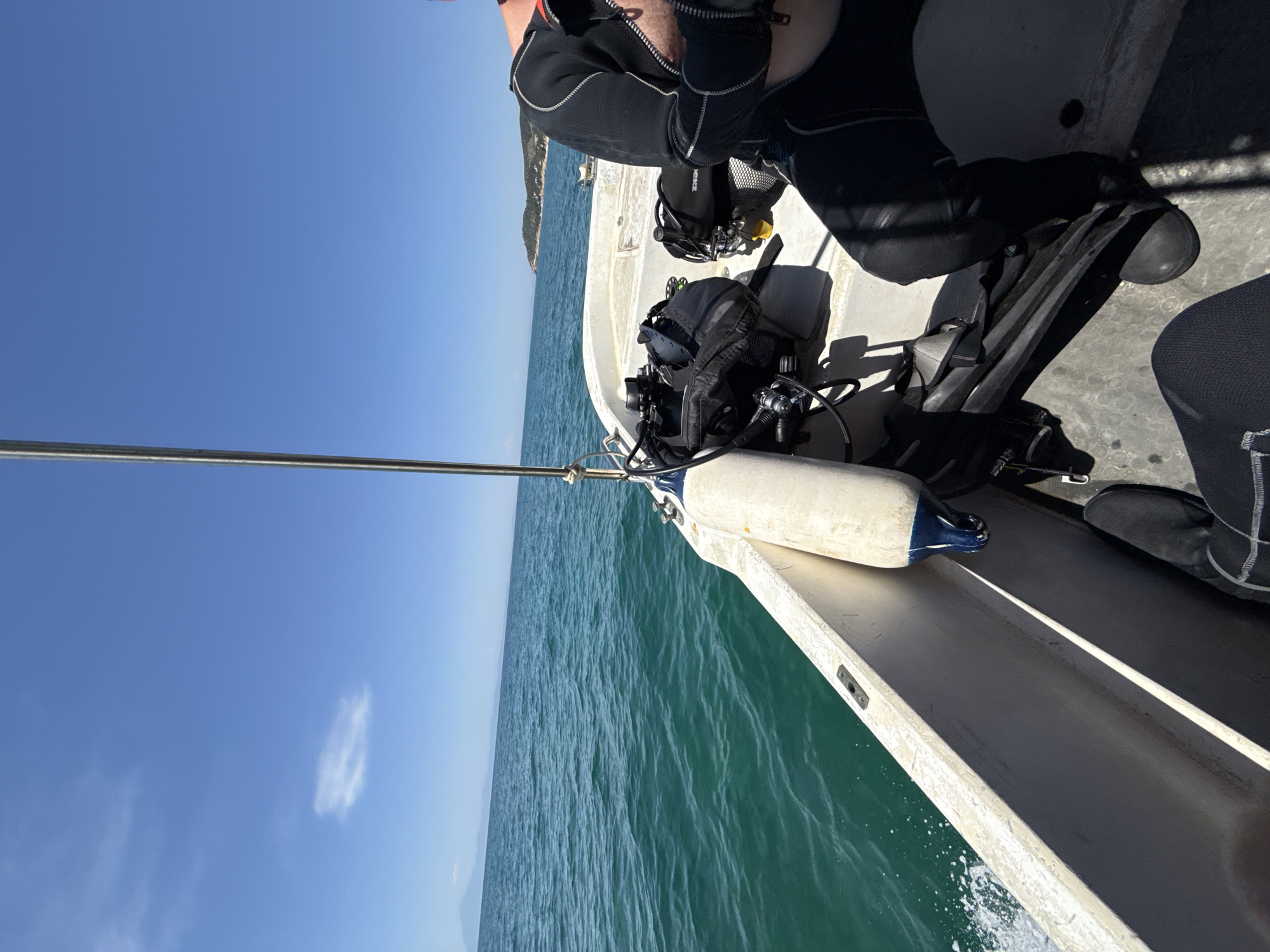 Scuba divers heading out on calm Aegean waters near Limenaria
