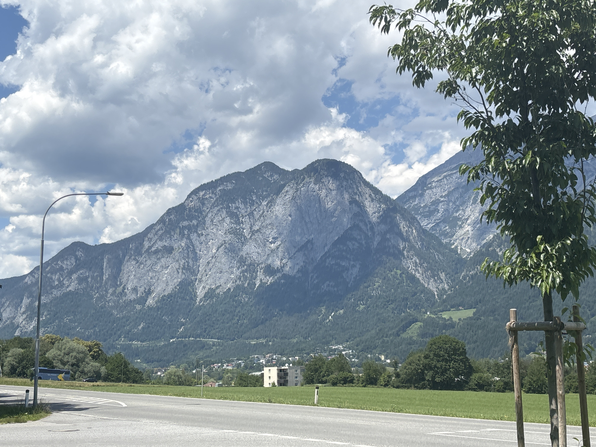 Innsbruck spreads across the valley floor beneath cloudy Alpine peaks