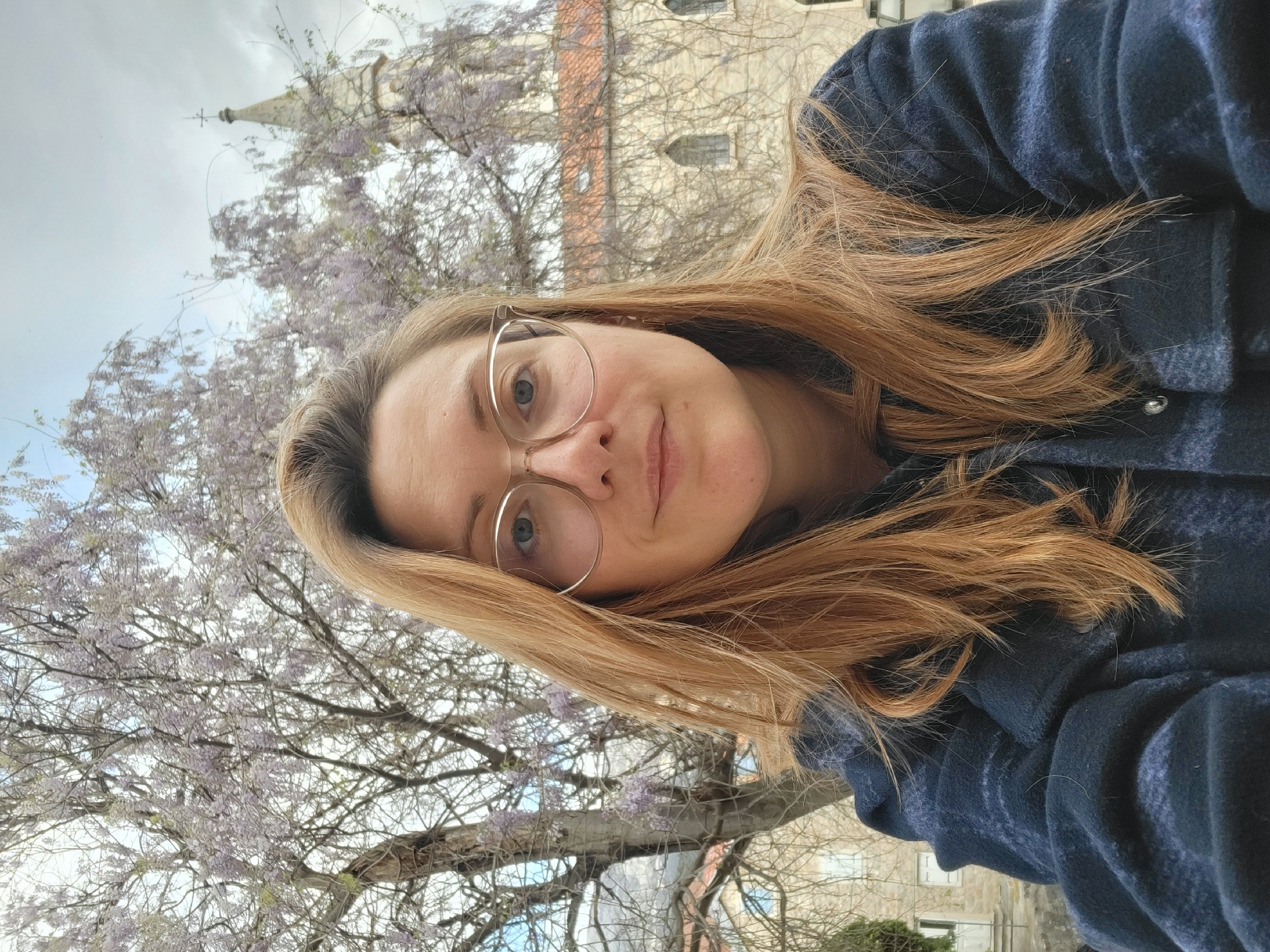 Tourist with dog explores historic Budva amid spring blooms