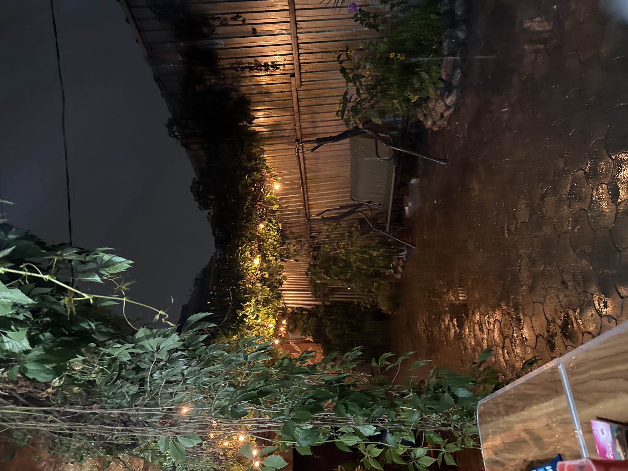 Rainy night on a lit patio in Almaty
