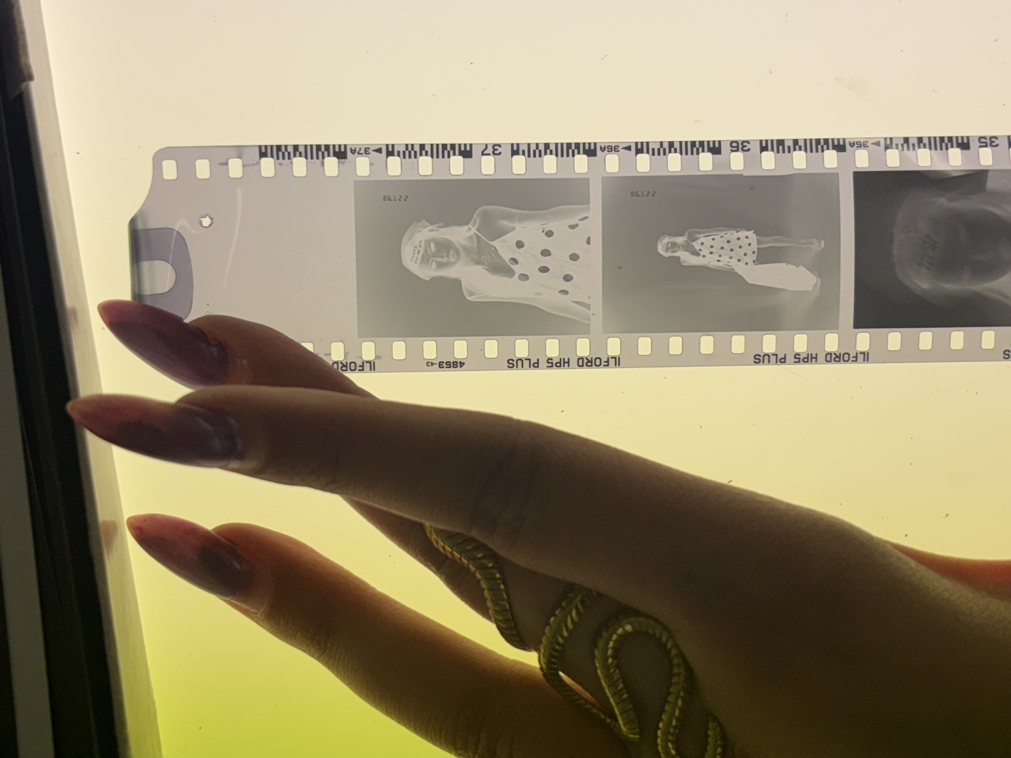 Photographer reviews film negatives in Milan studio session