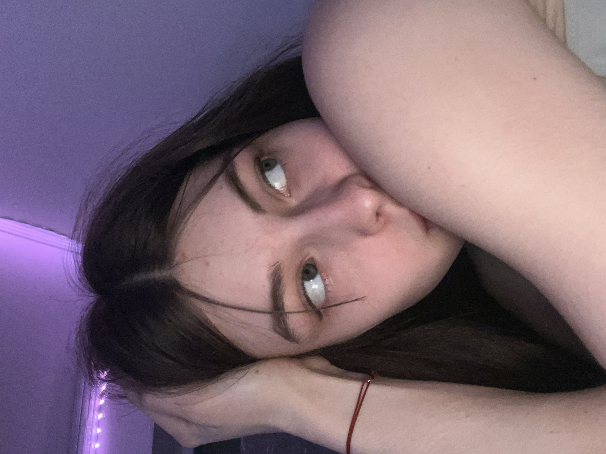 Woman takes selfies in colored lighting in Saint Petersburg