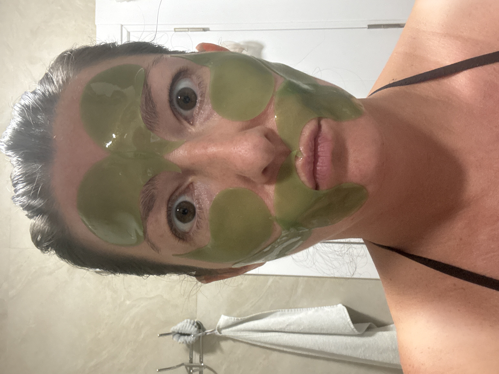 Green face mask selfie paired with a #SelfCare graphic