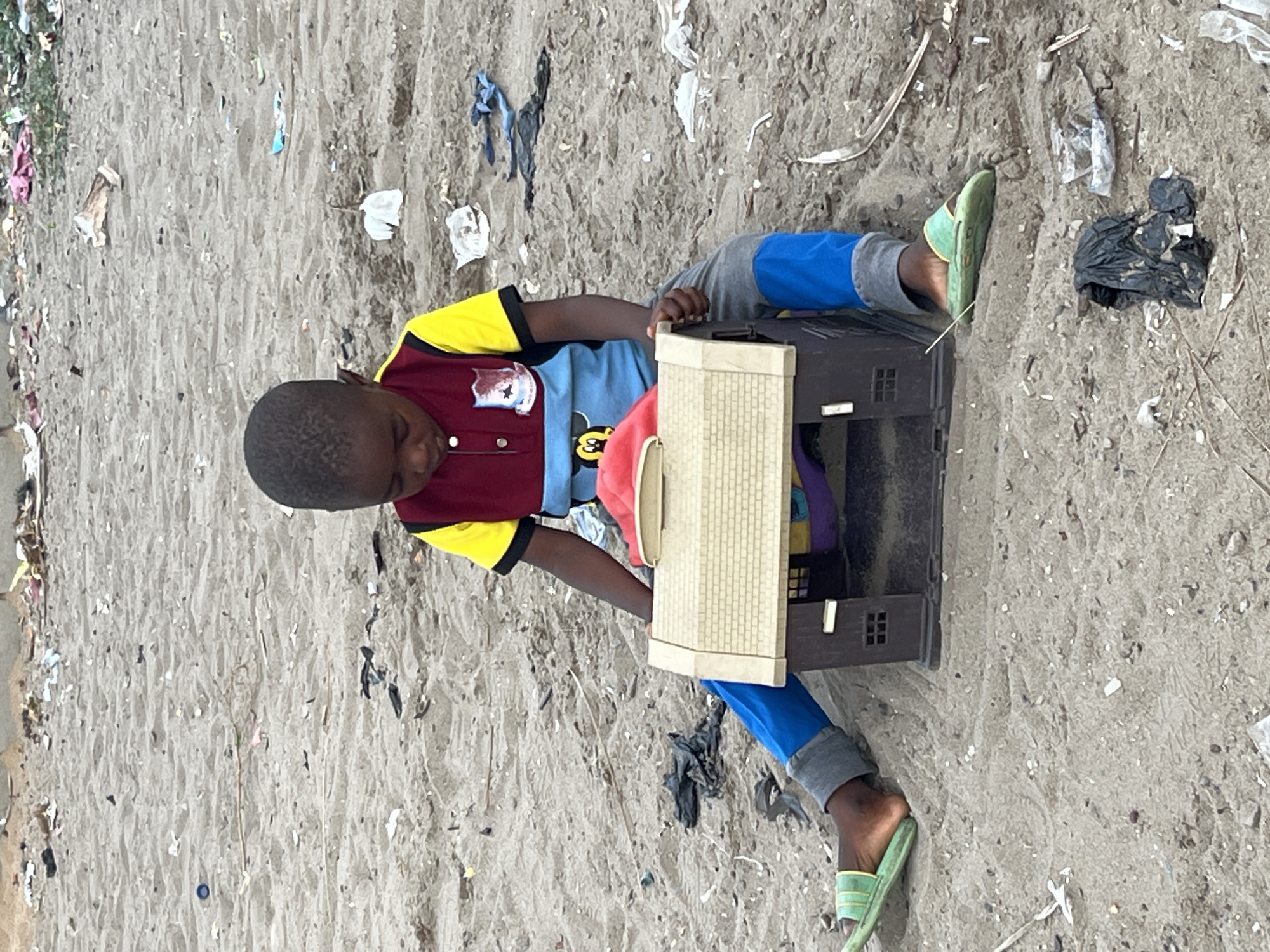 Children play on sandy surface in Badagry, Nigeria