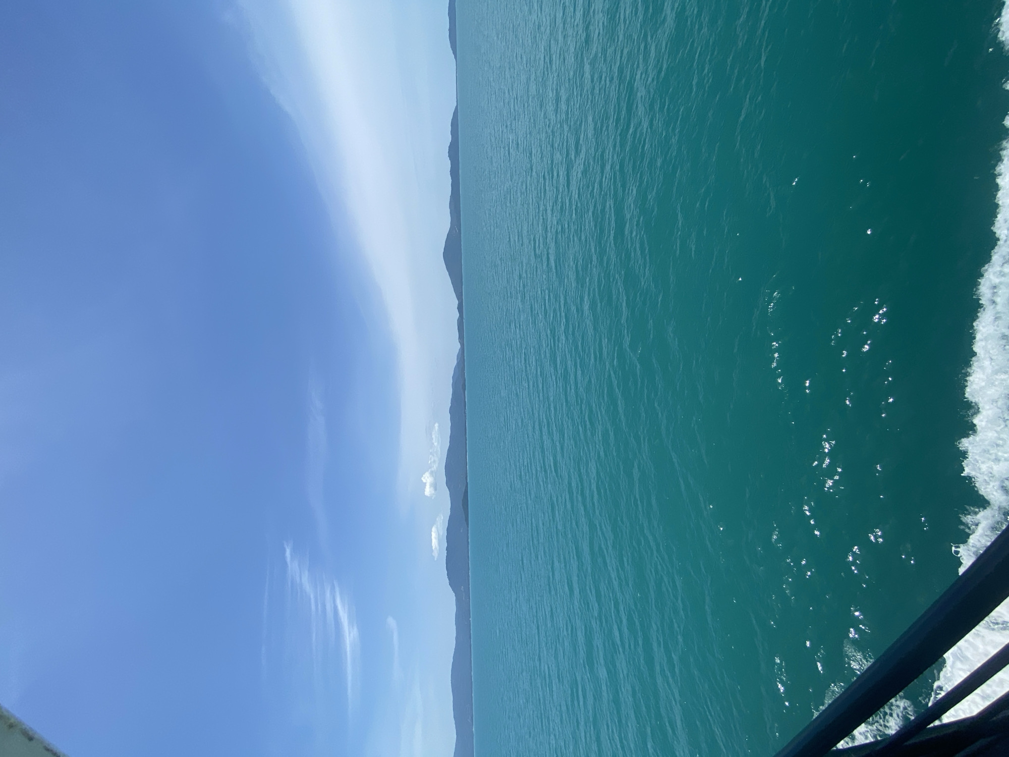 Ferry crossing bright turquoise waters off the Thai coast