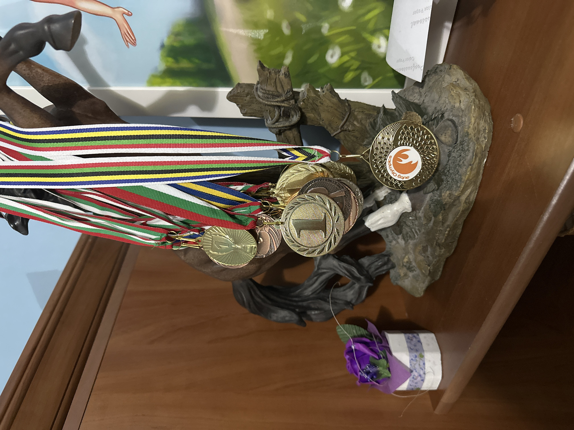 Home office workspace with medals and travel souvenirs displayed