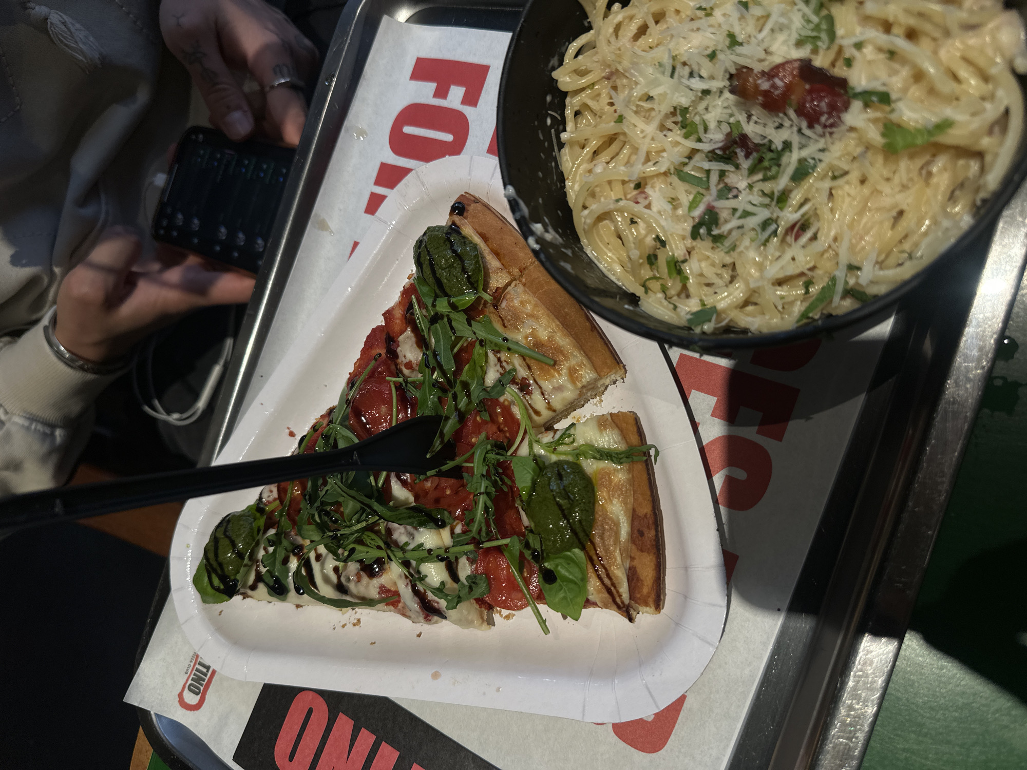 Customer enjoys pizza lunch at Yerevan restaurant