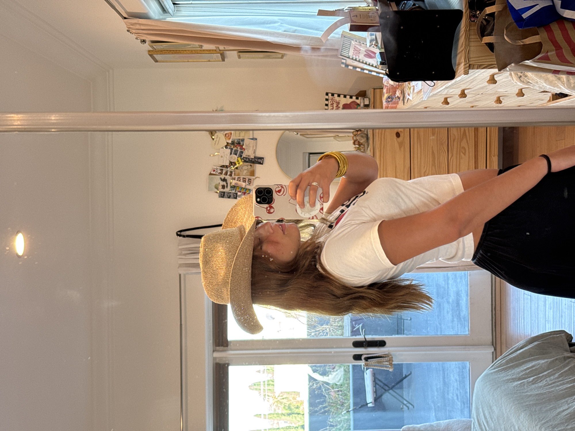 Woman takes mirror selfie in cowboy hat, Los Angeles