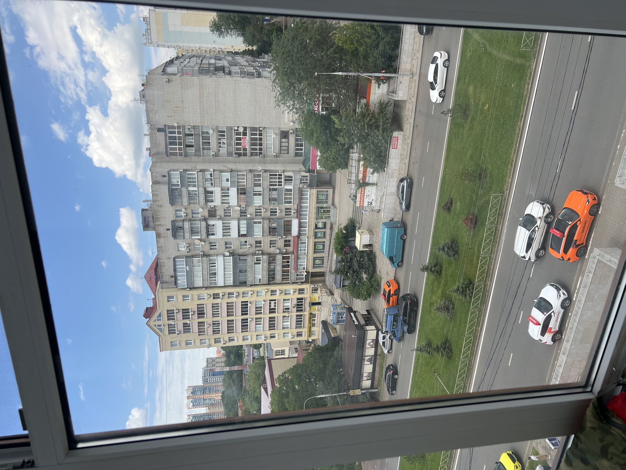 Art supplies and city views from a window-side workspace