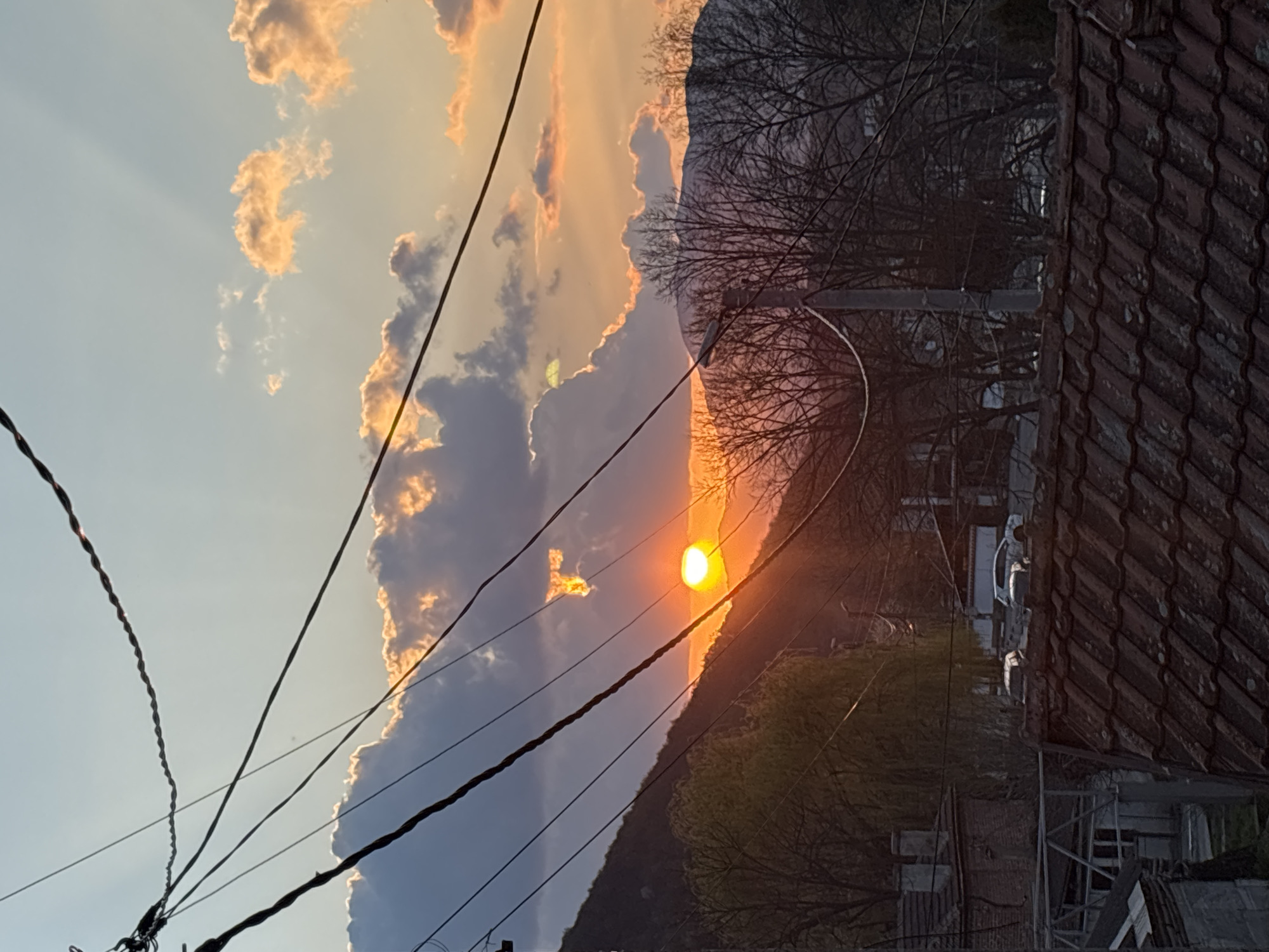 Day-to-night transition captured in residential area with sunset, streetlights