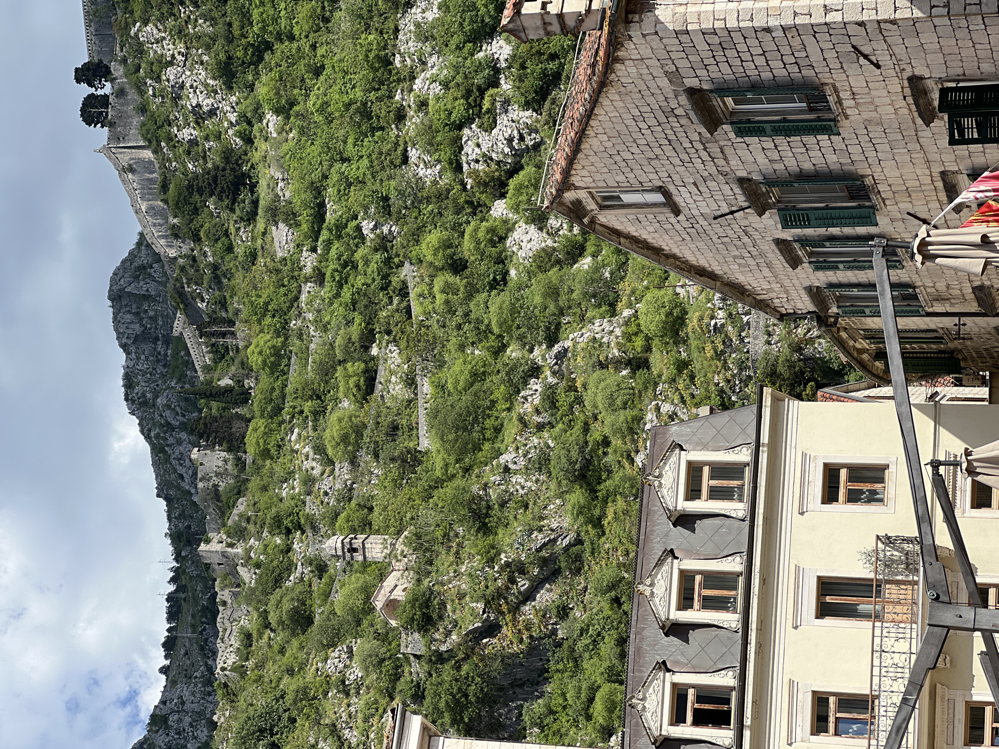 Tourist documents medieval Kotor and neighboring areas during afternoon visit