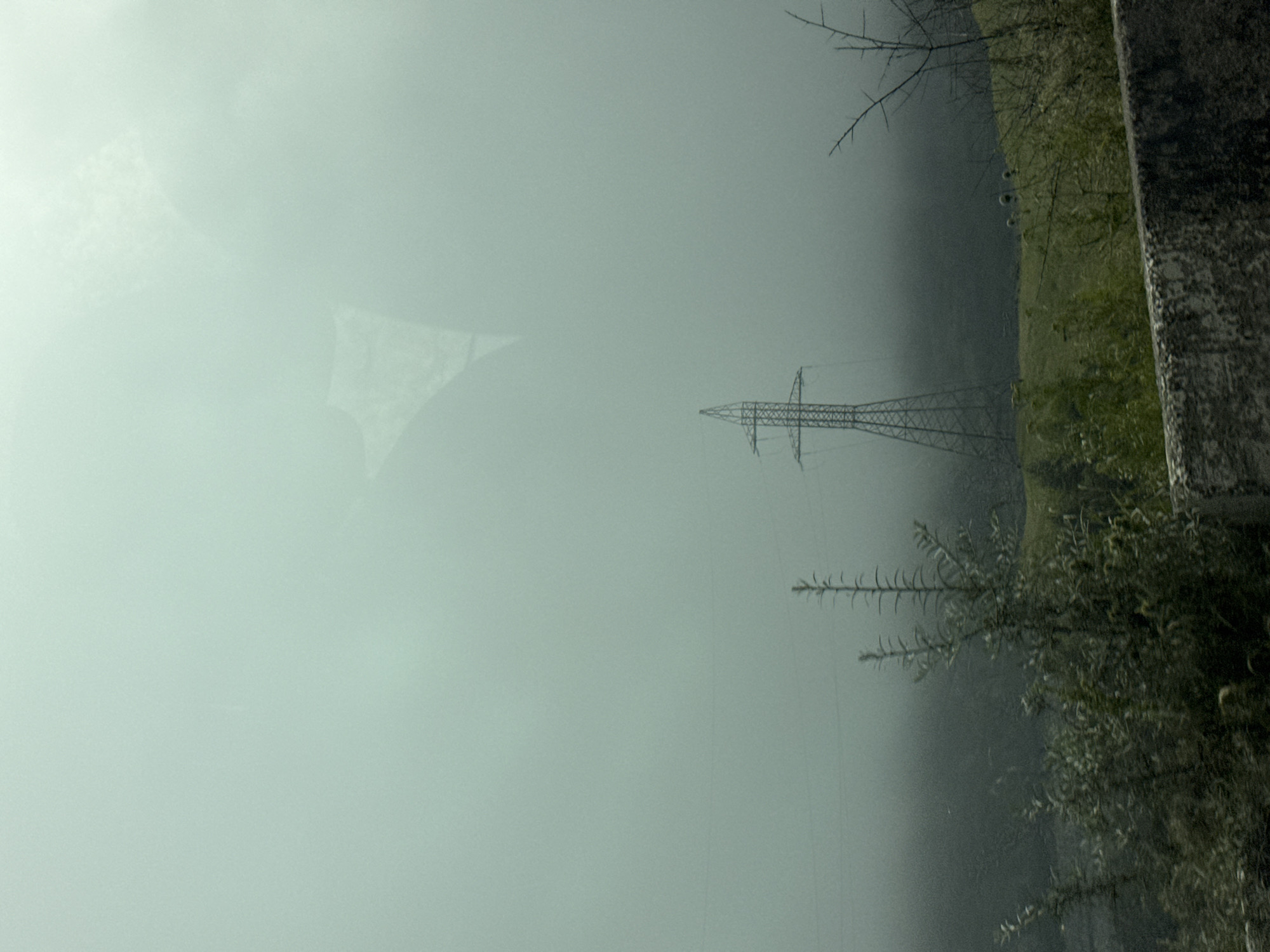 Foggy mountain road and power infrastructure in Tsdo, Georgia