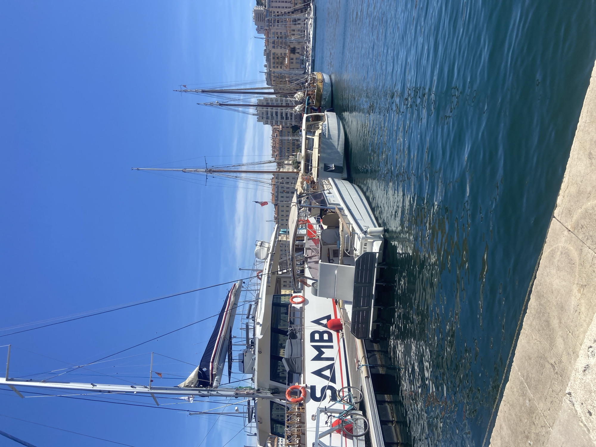 Marina boats and tiered fountain documented in afternoon scenes