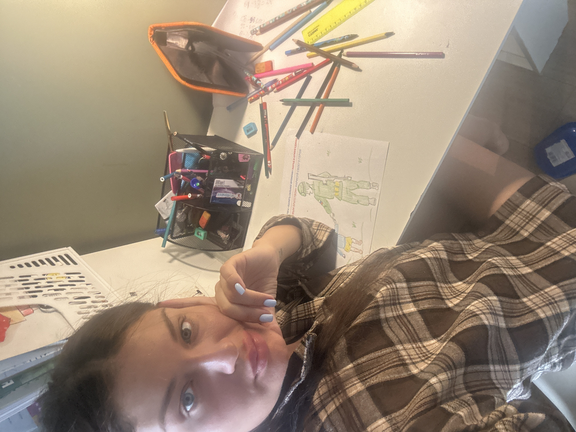 Woman takes selfie at art supply-filled desk in Khimki