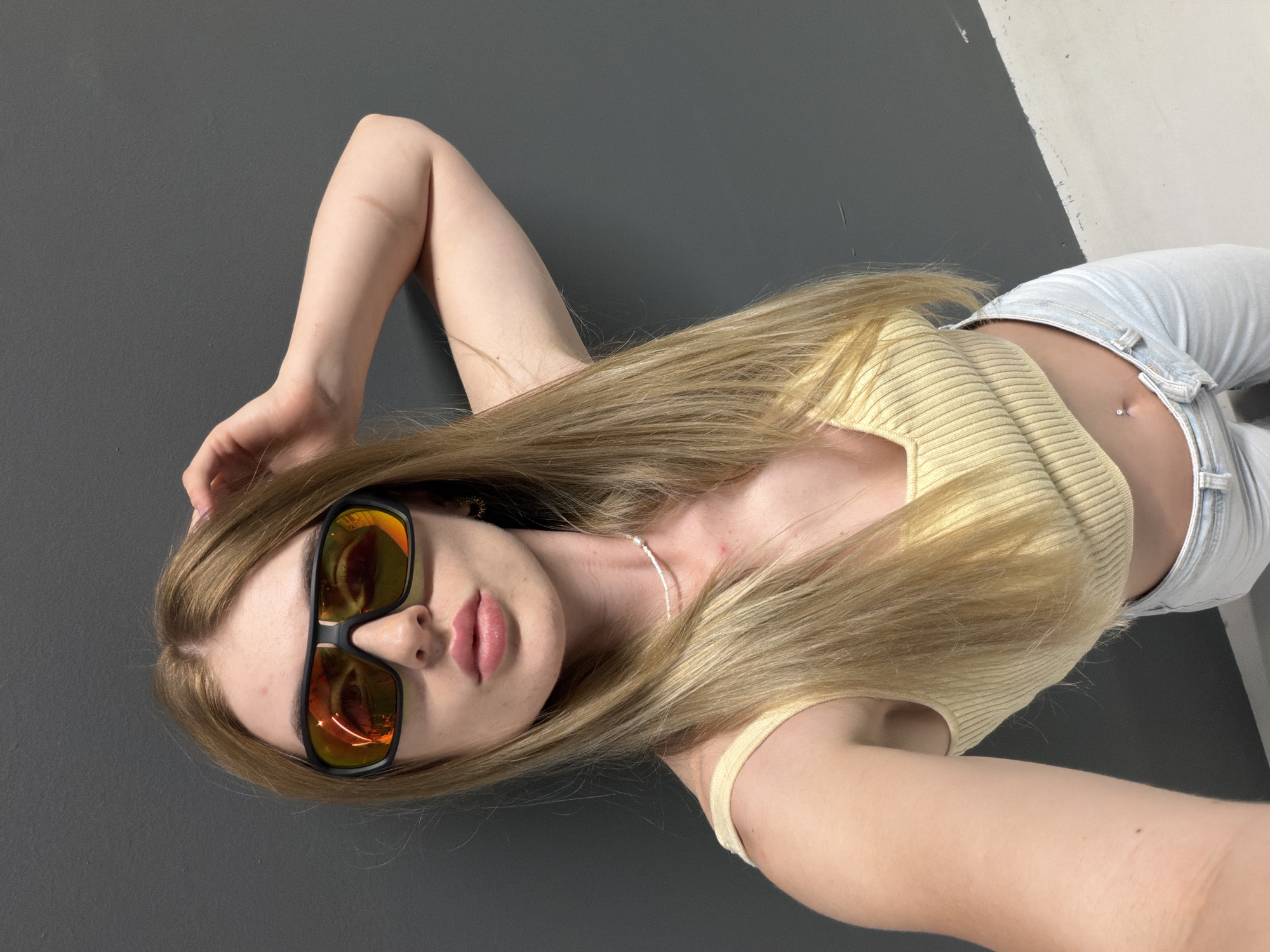 Selfie session in a gray-walled retail corridor