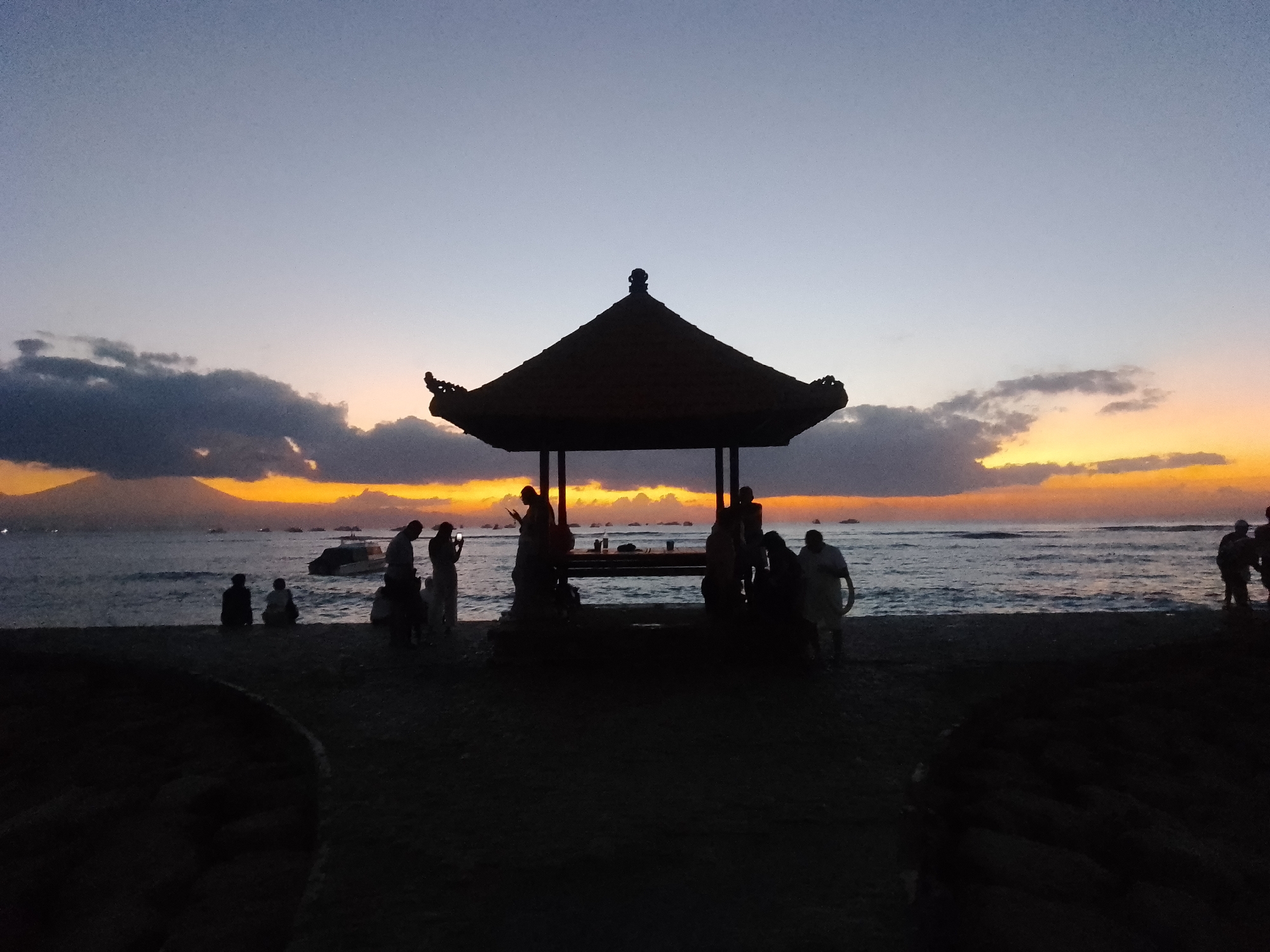 Sunset beach gathering documented in Denpasar, Indonesia