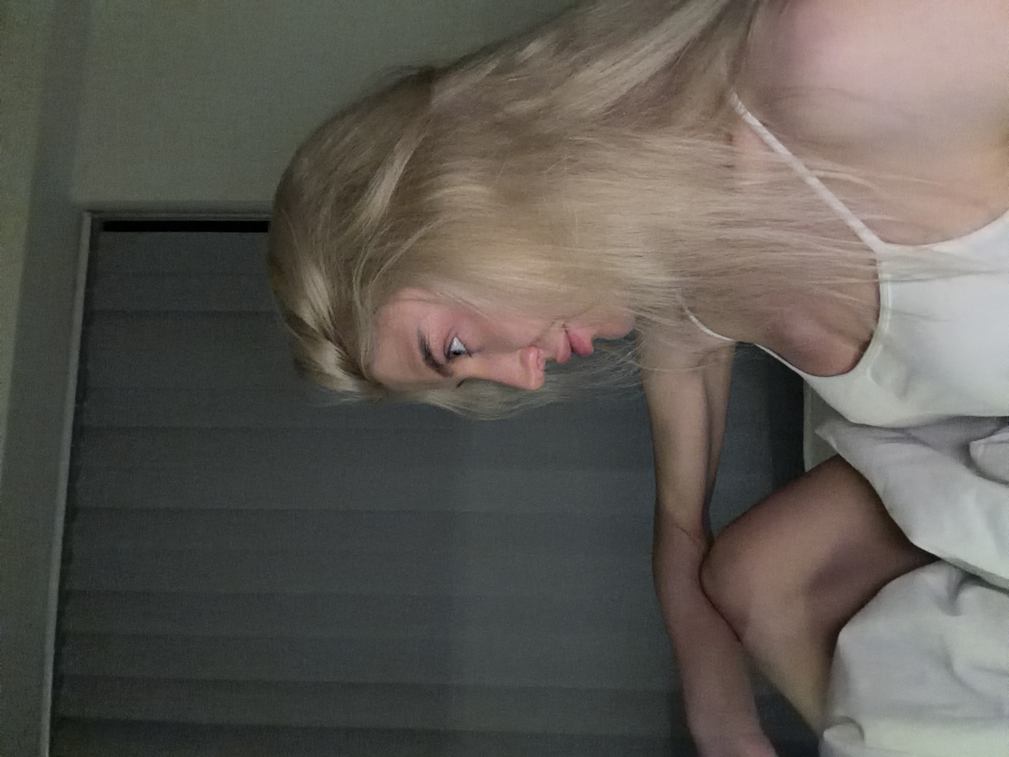 Woman sits in bedroom during evening hours in Belgrade