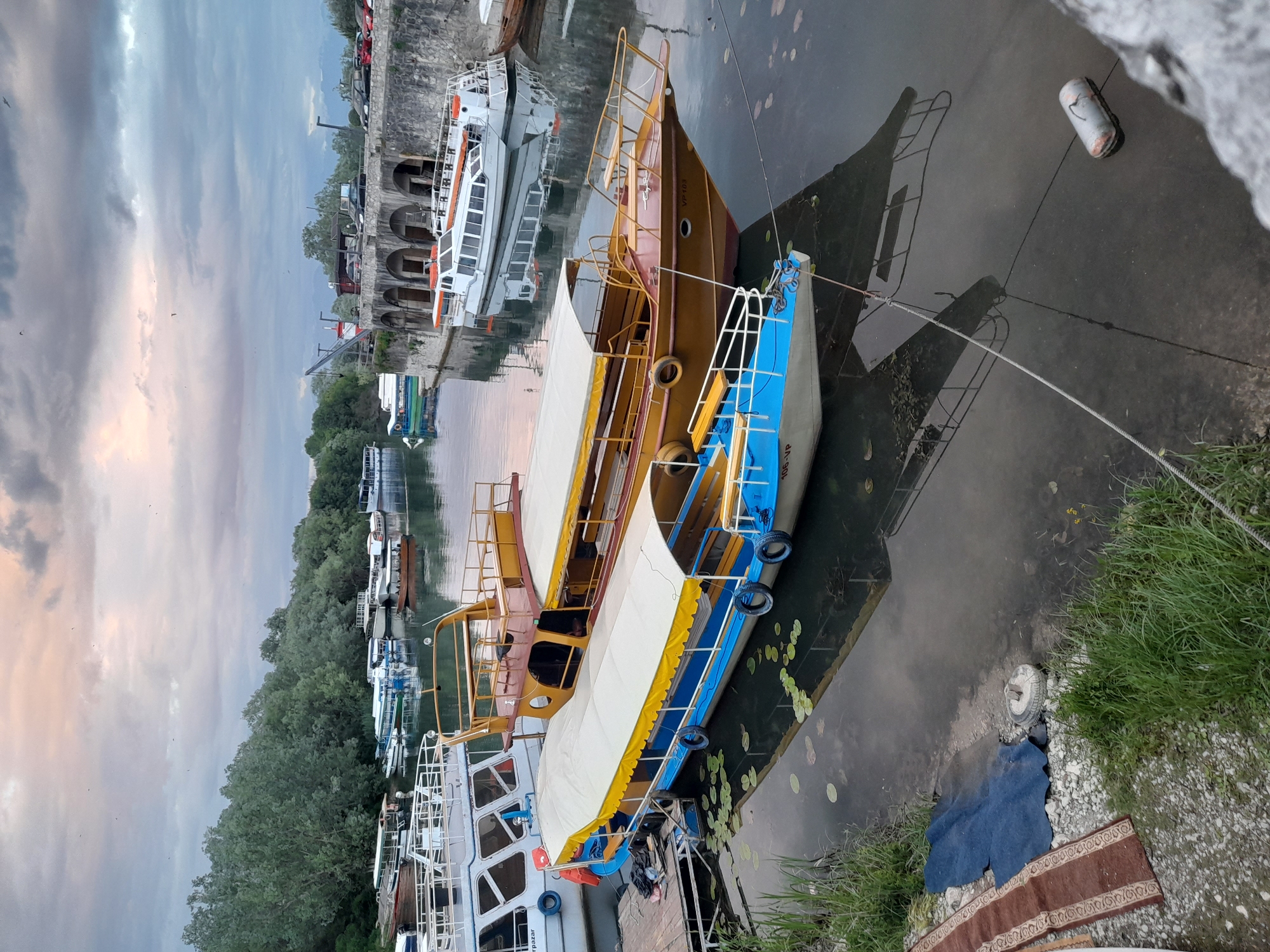 Mixed fleet of boats docked at waterfront quay