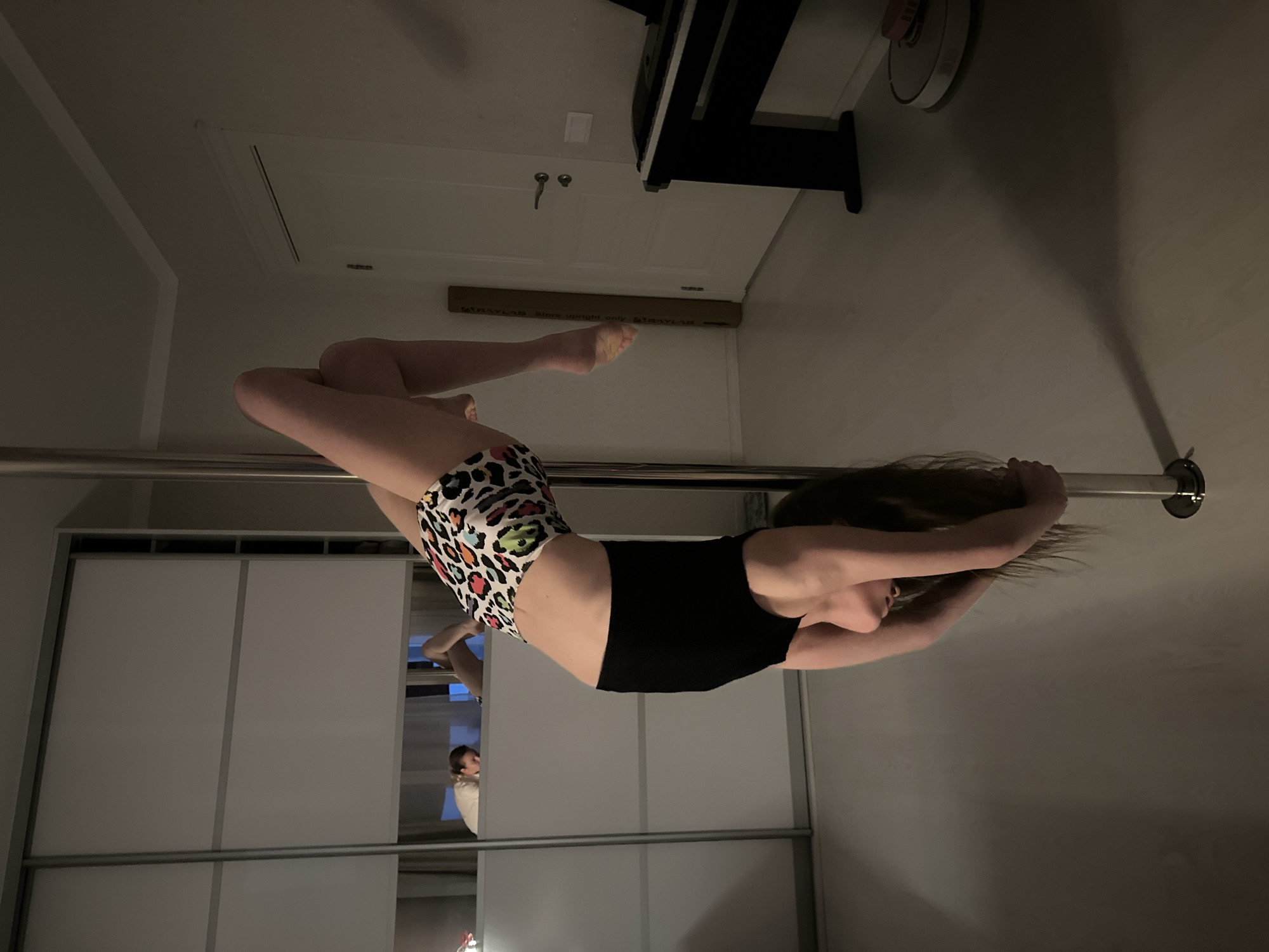 Woman performs pole dancing routine in Tomilino home