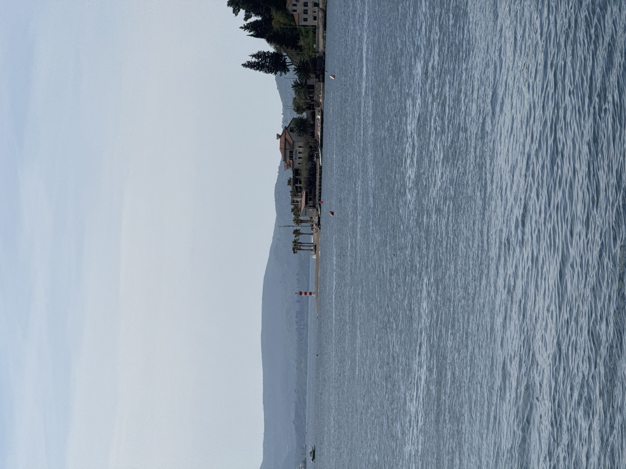 Ferry crossing documented near Montenegro coast with motorcycle passenger