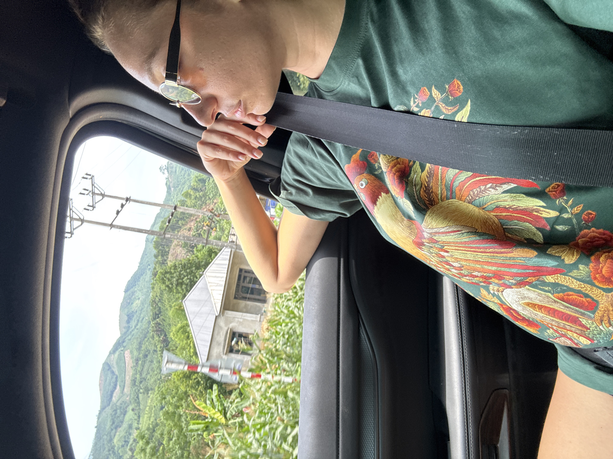 Passenger enjoys scenic mountain drive through rural Vietnam