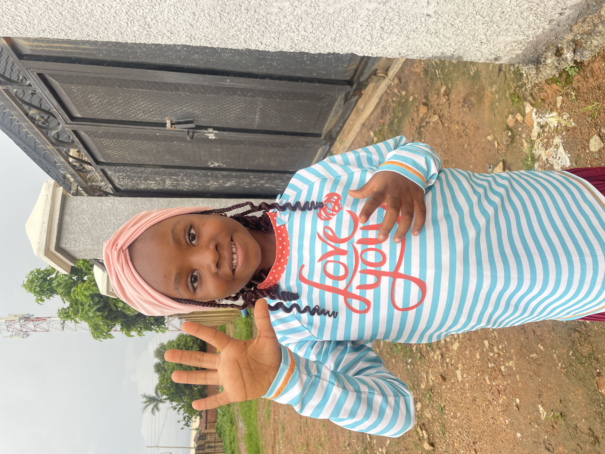 Five-finger gesture in an outdoor moment in Jos, Nigeria