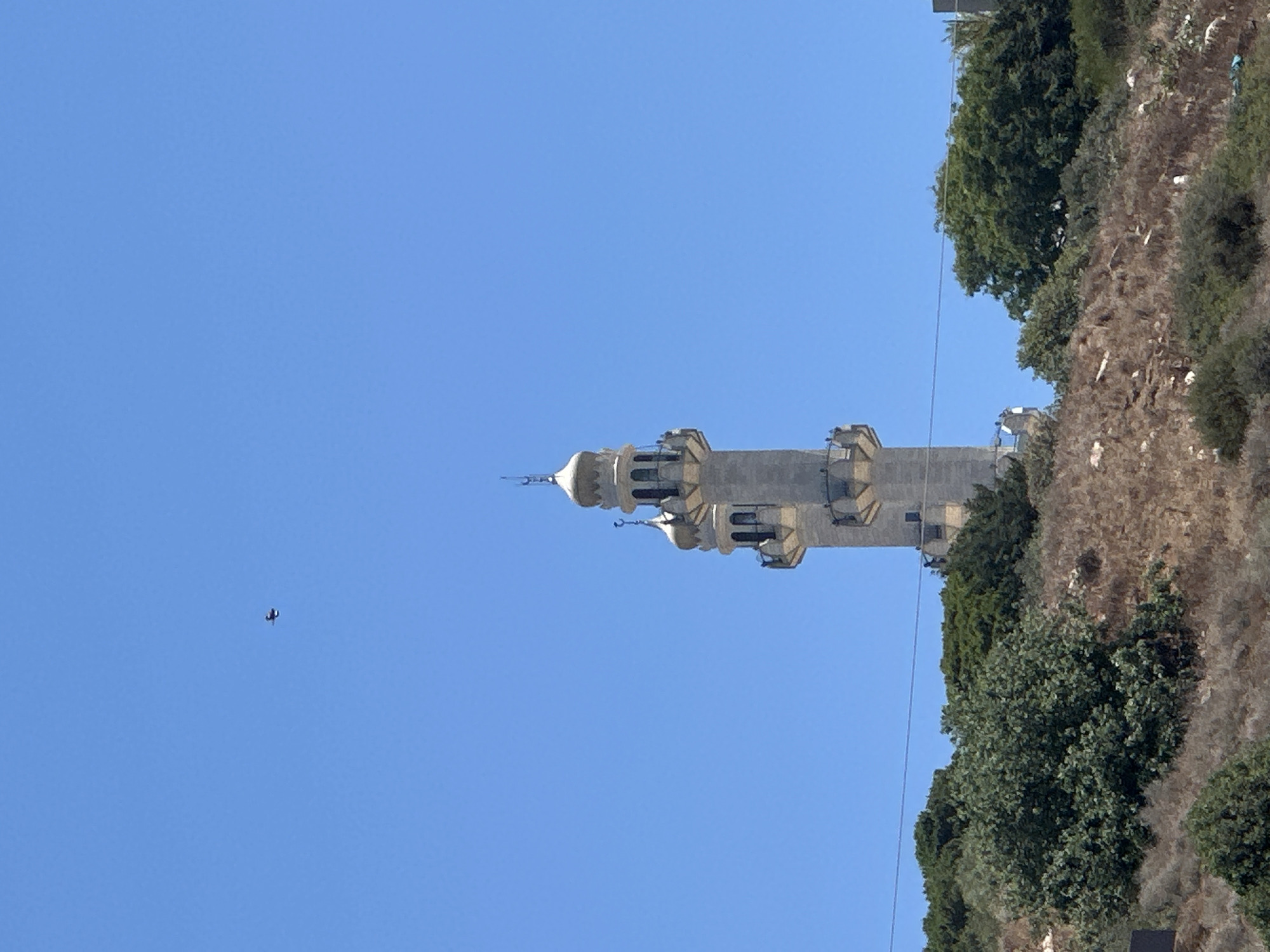 Haifa street-level scenes: minarets, hillside housing, and active construction