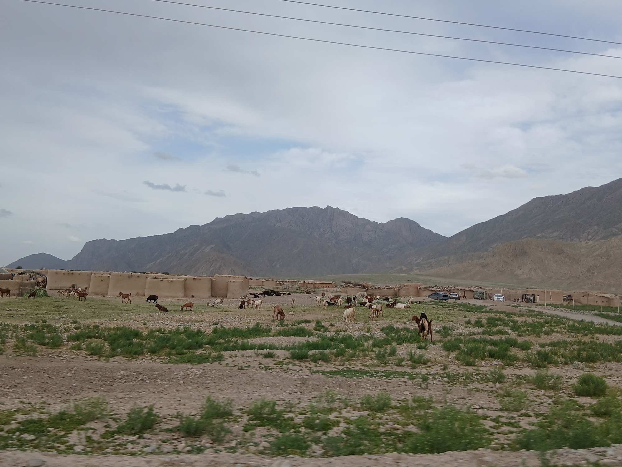 Motorcyclist travels through rural Pakistan villages amid traditional architecture