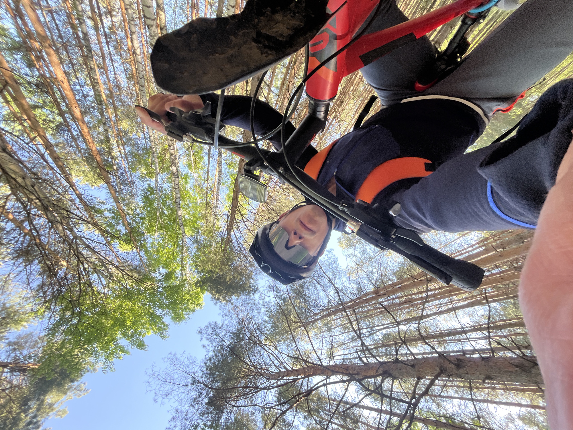 Cyclist documents sunny forest ride near Chaikovsky, Russia