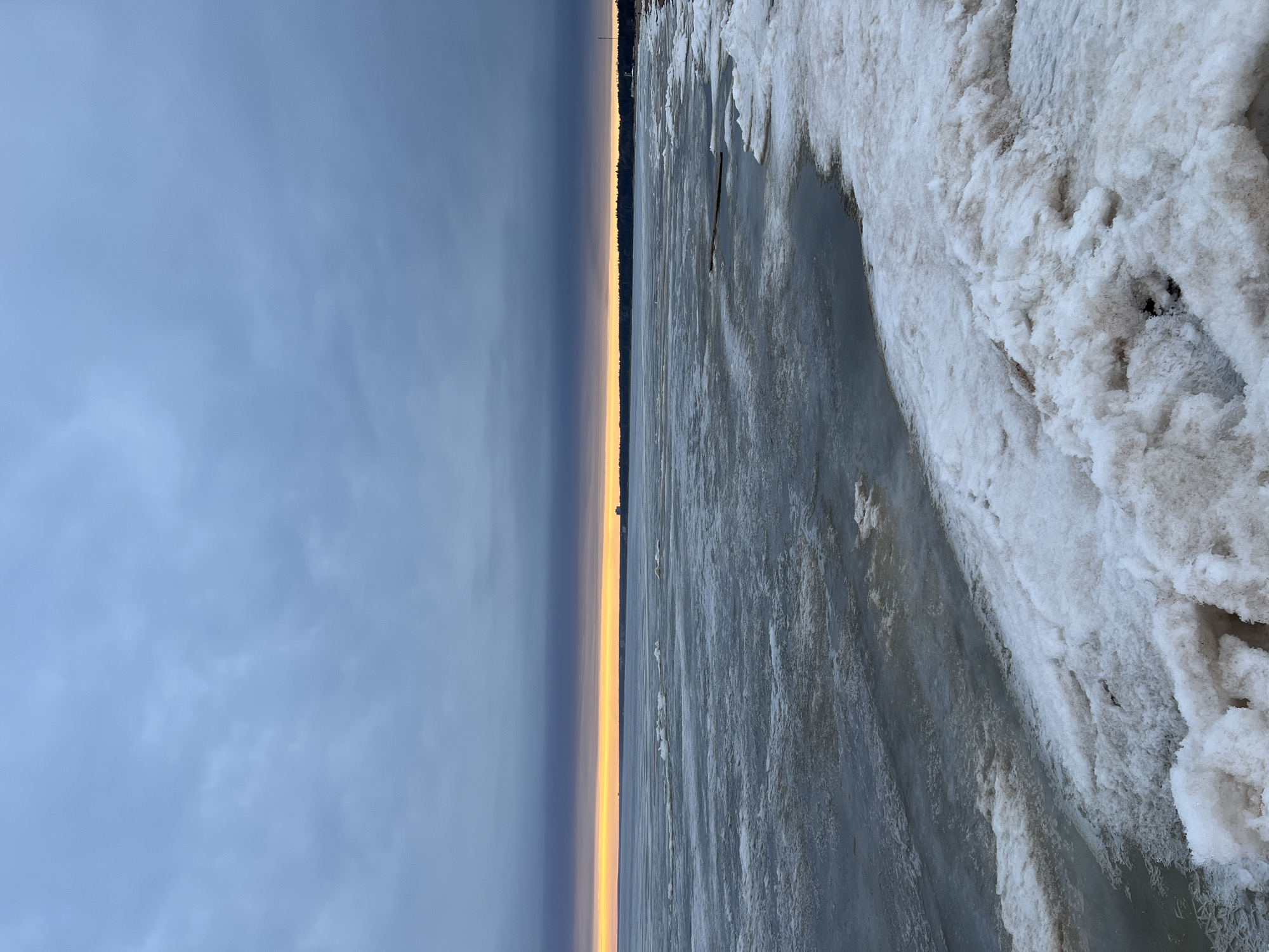 Nordic walker exercises on frozen Russian coastline