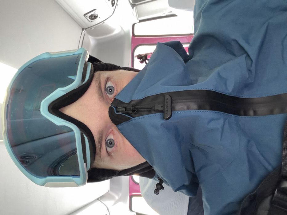 Skiers unload gear from pink van in snowy Kutchan