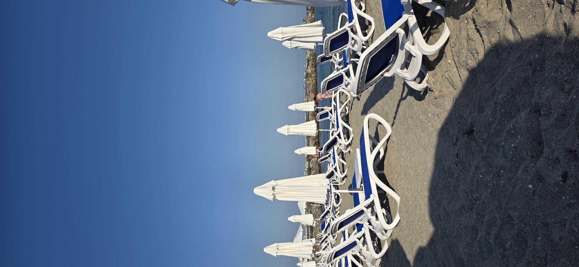 Quiet beach day at Pomorie, chairs out, sea calm