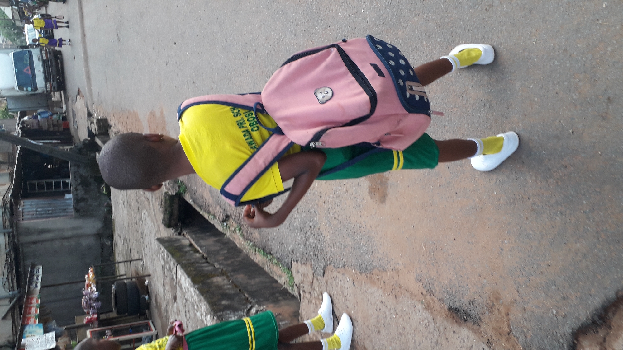 School children commute through Onitsha streets during morning hours