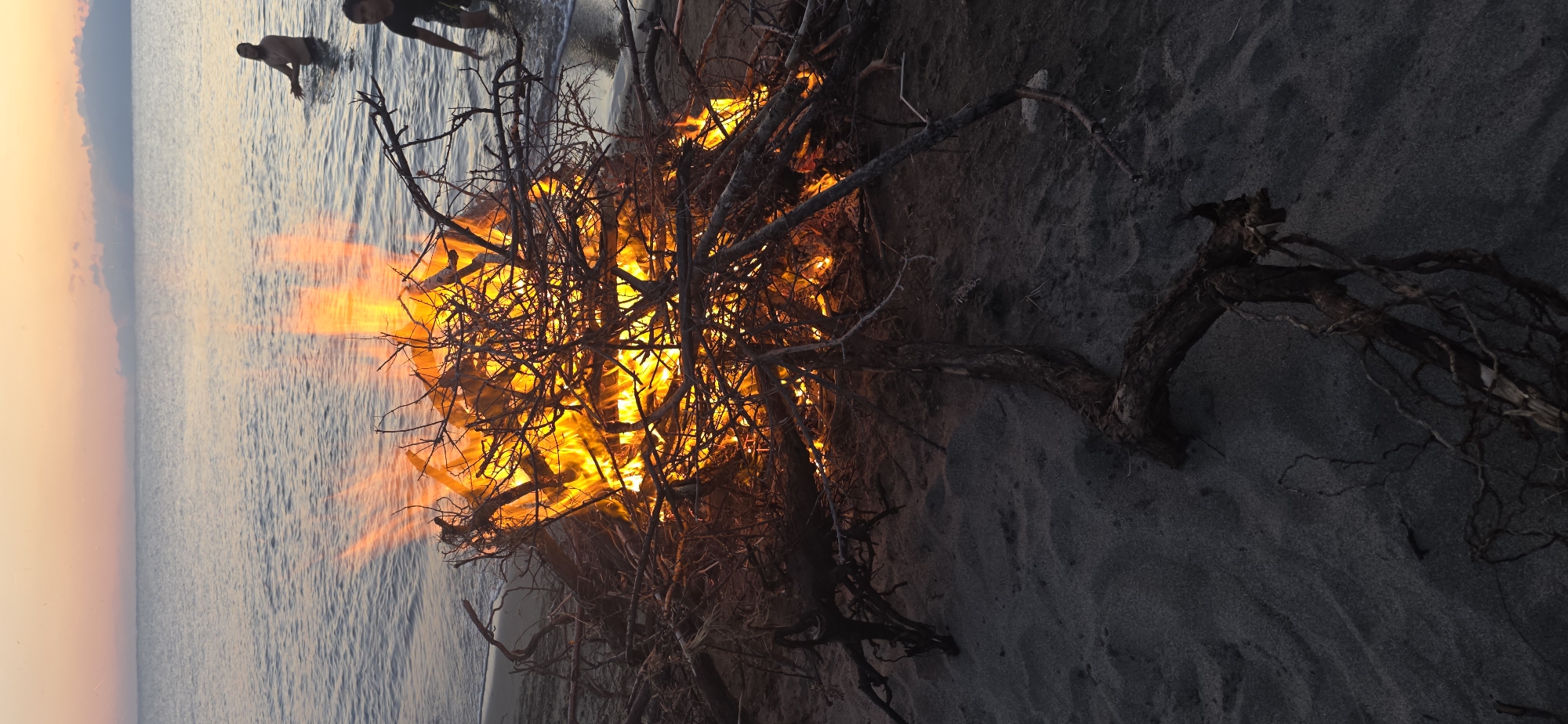Sunset bonfire and wading at a Kyrgyzstan lakeside beach