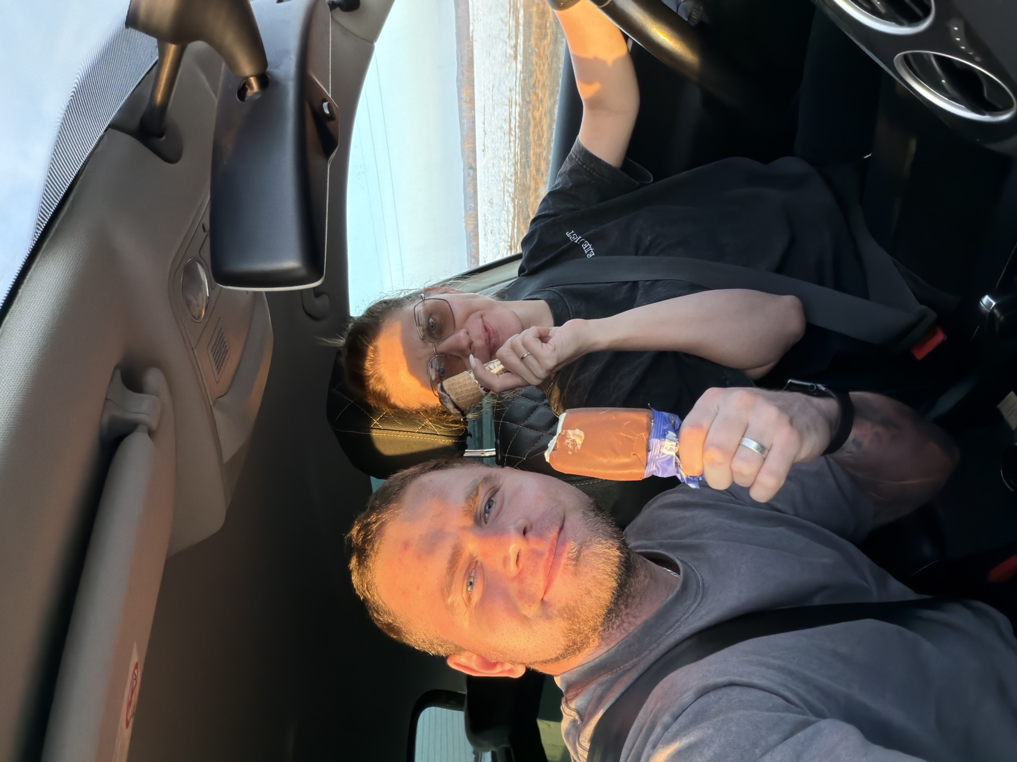 Couple enjoys ice cream treats while sitting in car
