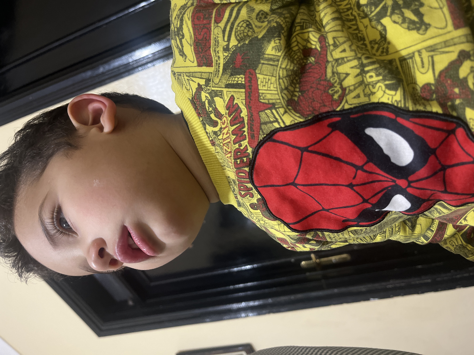 Child photographed in Spider-Man shirt indoors in Morocco