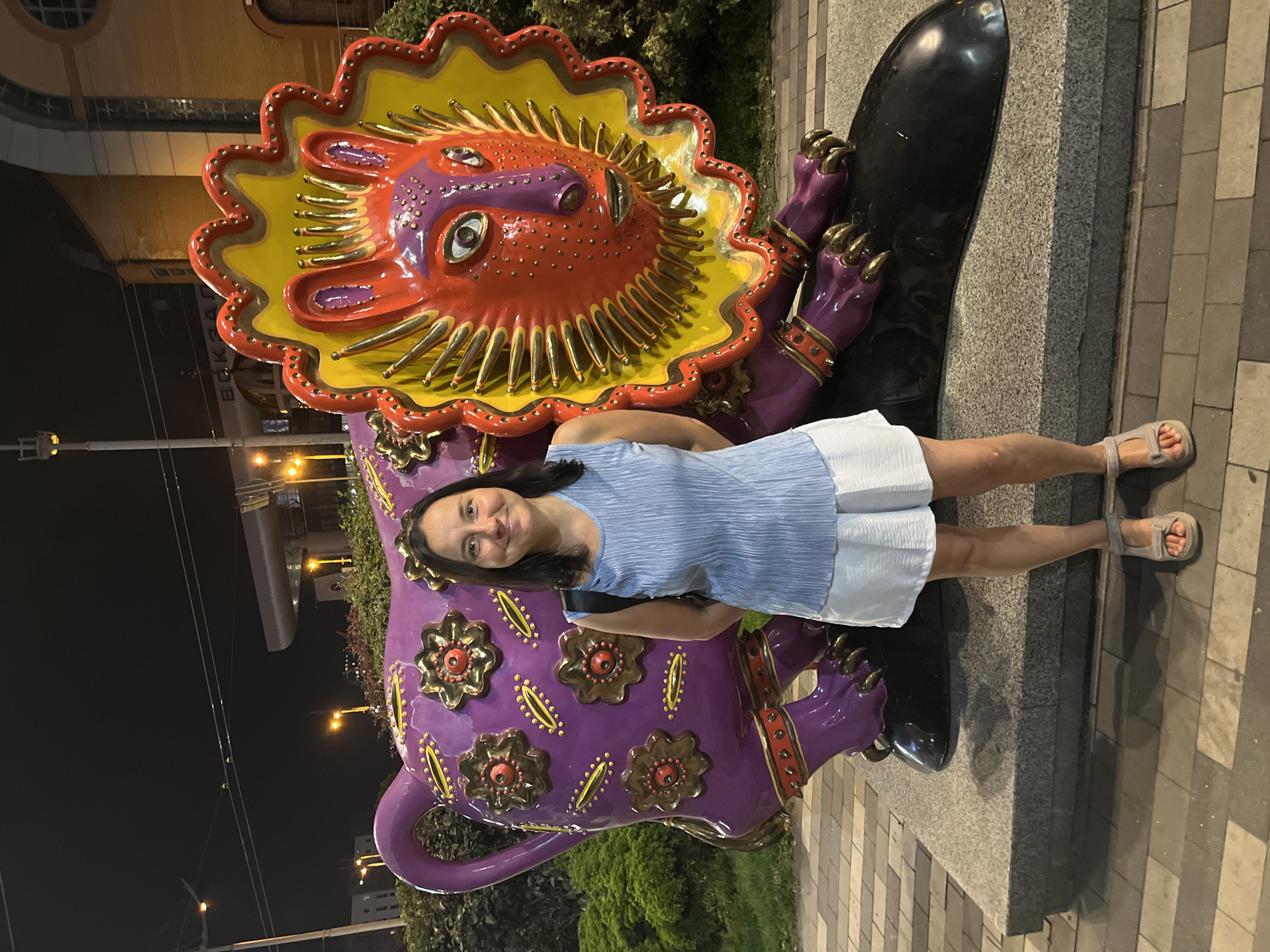 Posing with bold animal sculptures outside a Kyiv venue