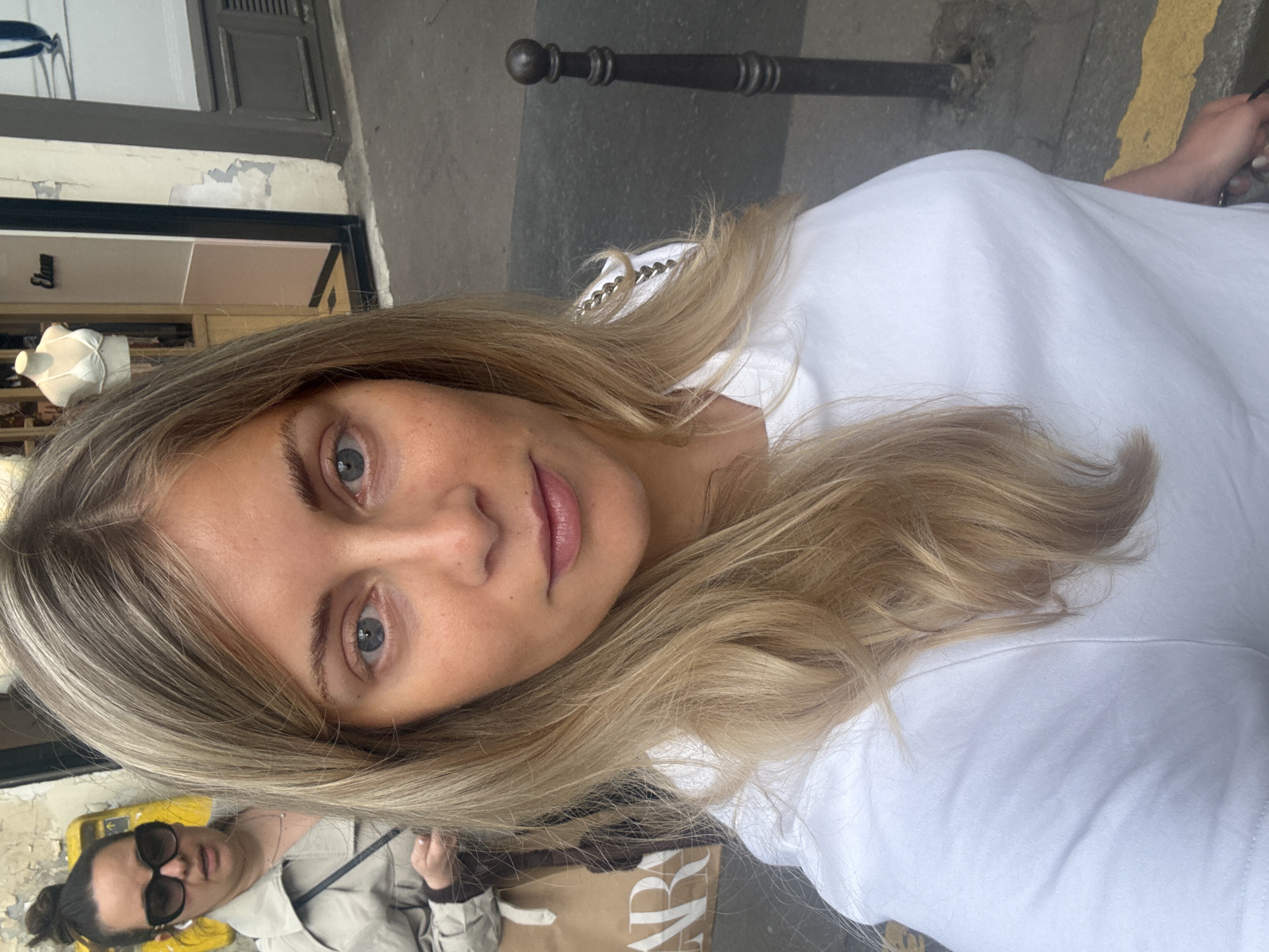 Woman takes selfie in Paris with friend in background