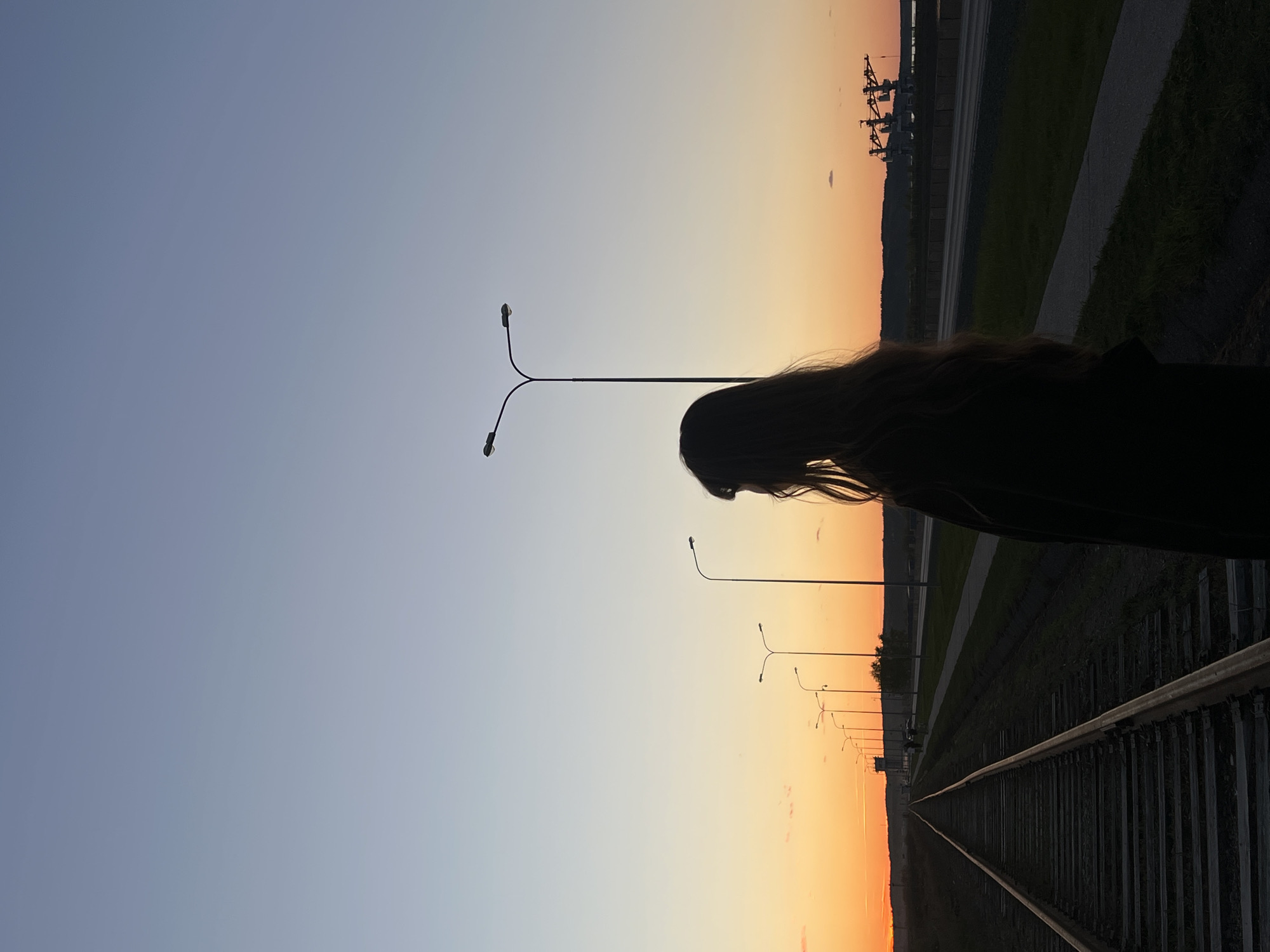 Sunset scenes captured near railway tracks and harbor in Chaikovsky