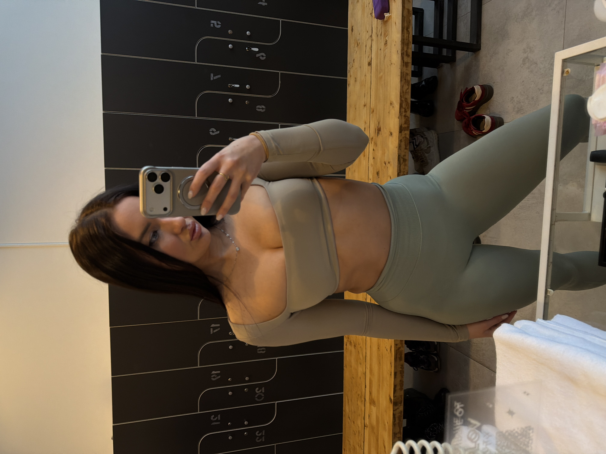 Woman takes mirror selfie in Moscow gym changing room