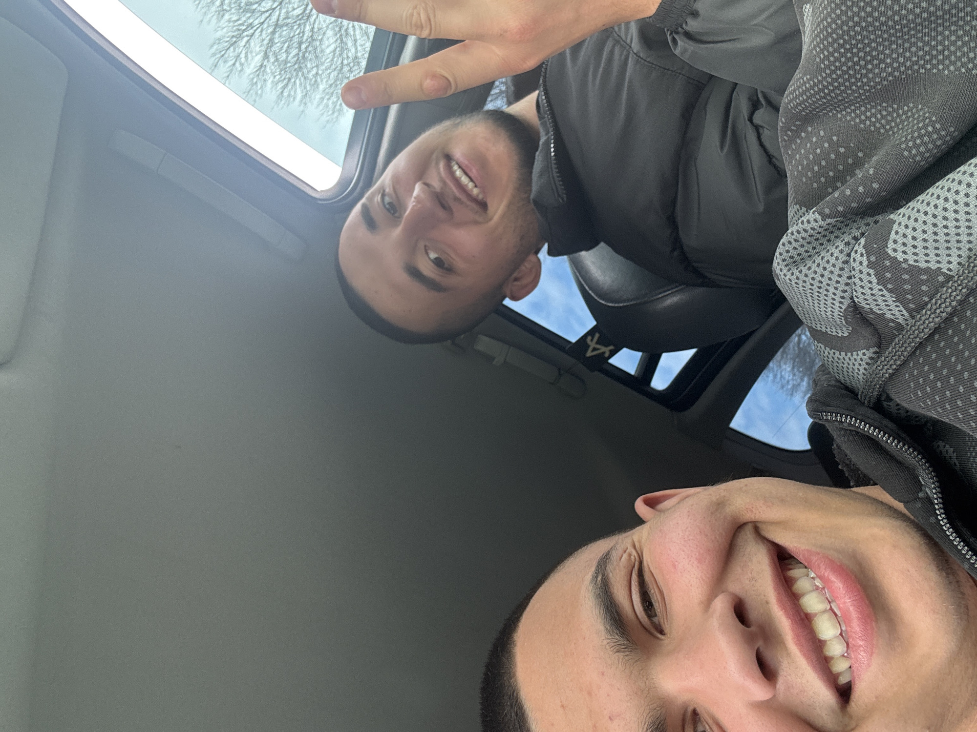 Two men pose for photo in car in Varna