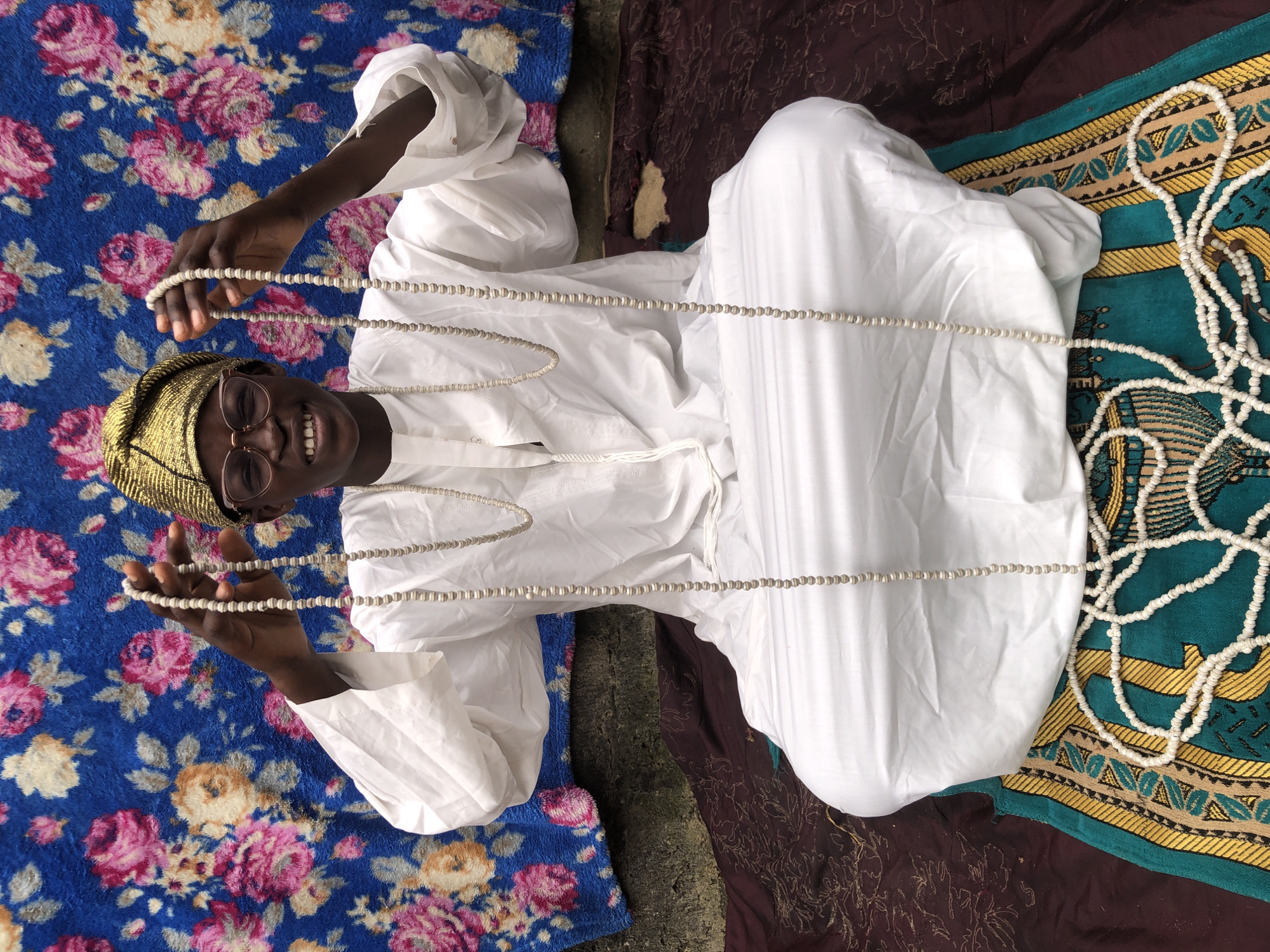 Traditional dress and prayer beads in Ado, Nigeria