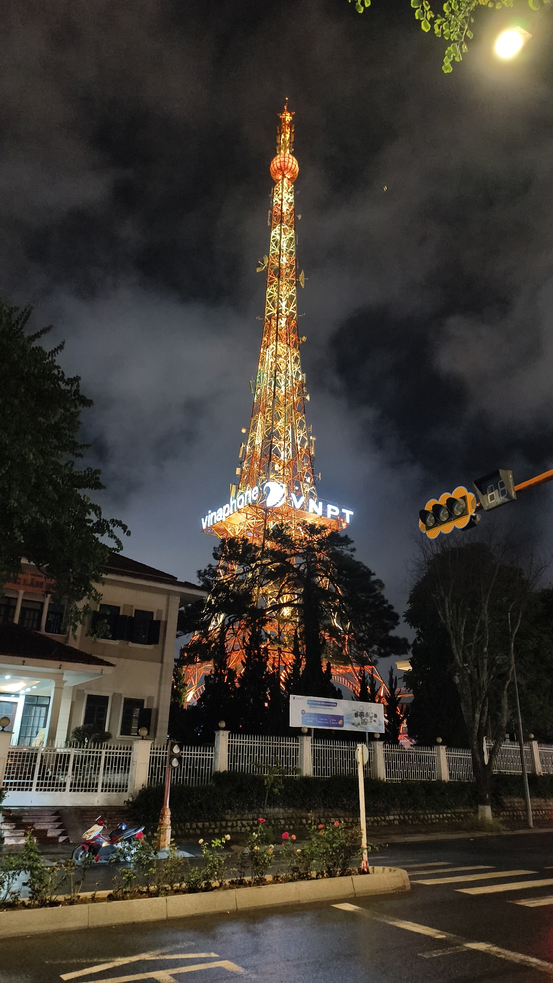 Da Lat's Vinaphone tower glows orange against the night sky