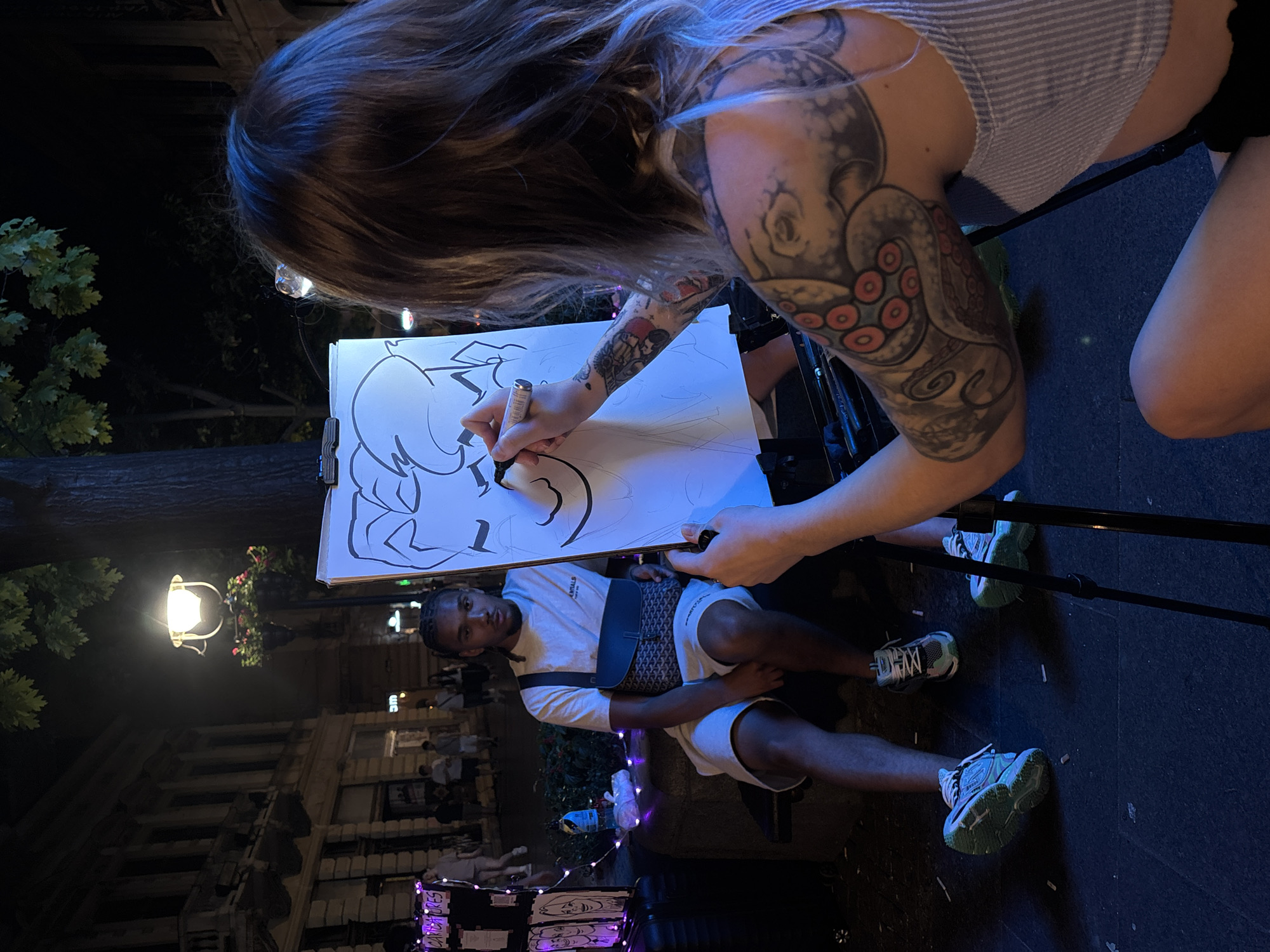 Street caricature artist at work in Belgrade at night