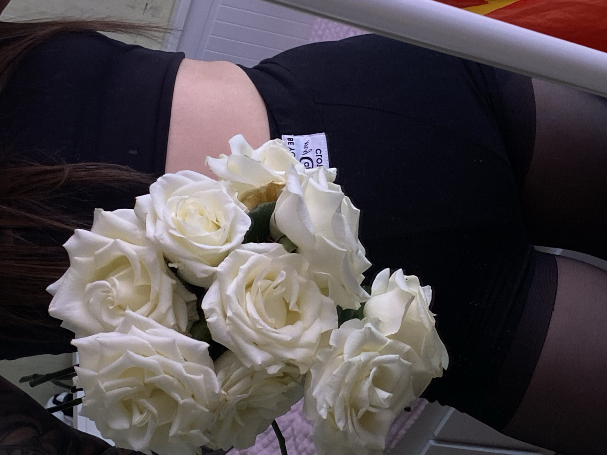 Person photographed with white roses in Votkinsk, Russia