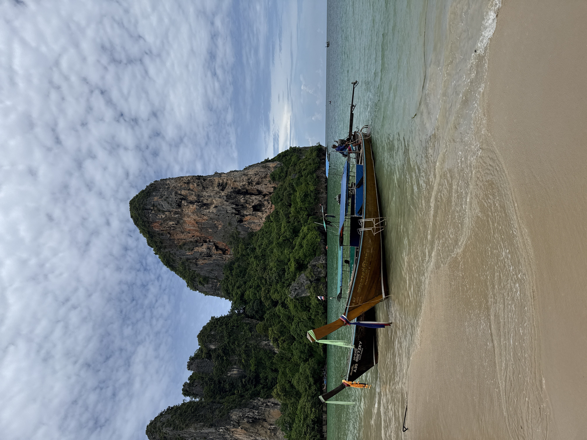 Longtail boats and limestone cliffs at Ao Nang beach